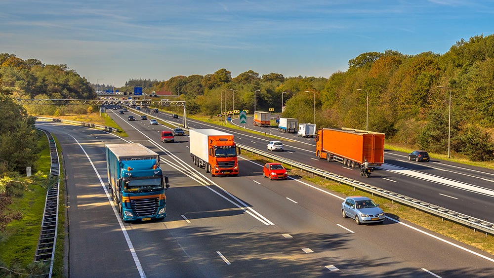 Commercial vehicles on a highway. If you have been injured in a tractor-trailer accident, a Goss Law Firm truck accident lawyer can help.